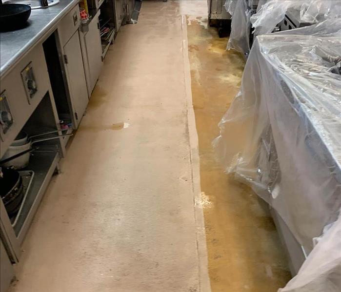 mid cleanup with covered appliances in commercial kitchen 