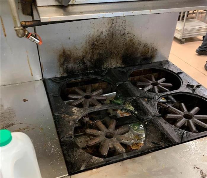 burned stove in commercial kitchen 