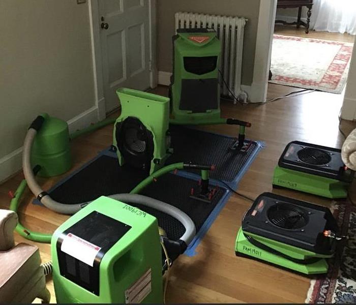 Green SERVPRO equipment is shown ready to repair water damage